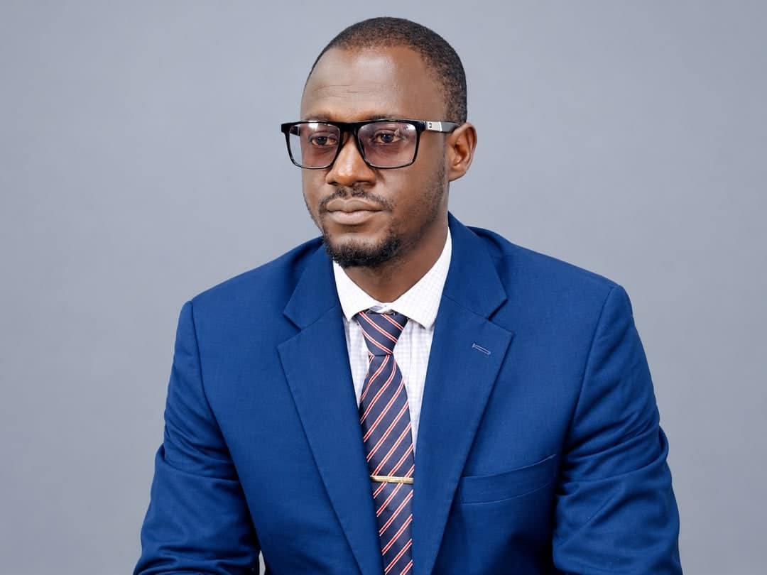Shebora Samba Kamara poses for a formal portrait, reflecting confidence, professionalism, and elegance.